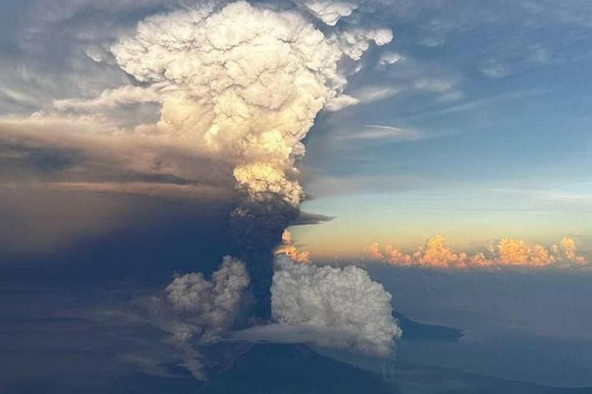 Ash column rises from Mount Ulawun, as seen from an aeroplane window, Papua New Guinea November 21, 2023, in this picture obtained from social media.