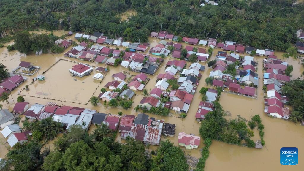 This aerial photo taken on Nov. 22, 2023 shows houses submerged by flood after heavy rain in Aceh Barat district, Aceh Province, Indonesia.