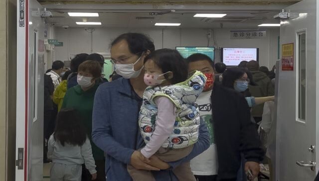 man carries child hospital