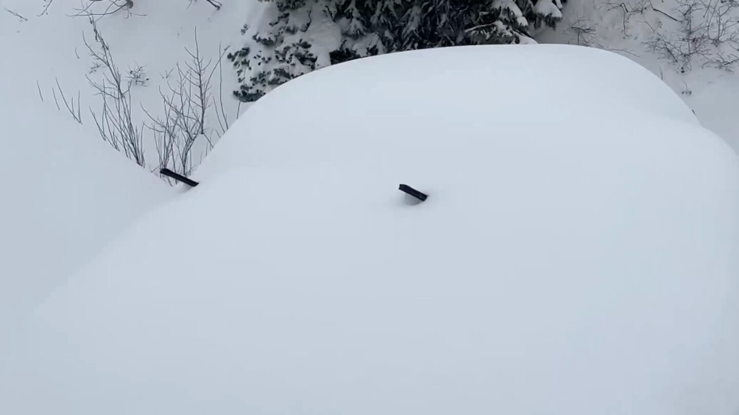 A vehicle buried in snow in Little Cottonwood