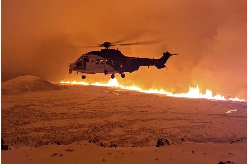 This image made from video provided by the Icelandic Coast Guard shows its helicopter flying near magma running on a hill near Grindavik on Iceland's Reykjanes Peninsula sometime around late Monday, Dec. 18, or early Tuesday, Dec. 19, 2023