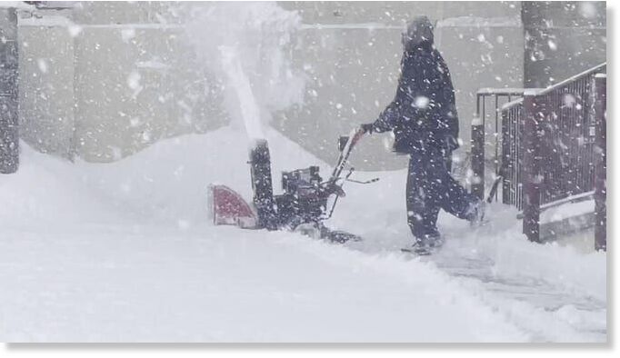 A man with a snow blower trying to keep up with the fast-falling snow in Flagstaff.