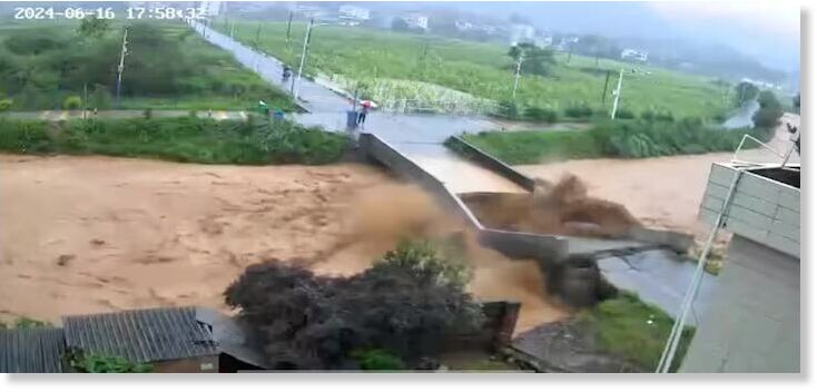 A bridge collapses following heavy rainfall and flooding in Dongshi Town, Meizhou City, Guangdong Province, China June 16, 2024, in this still image obtained from social media video.
