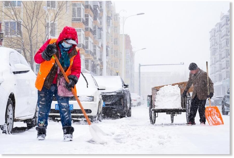 Sanitation workers clean snow in the Greater Khingan Range, northeast China's Heilongjiang Province, April 12, 2025.