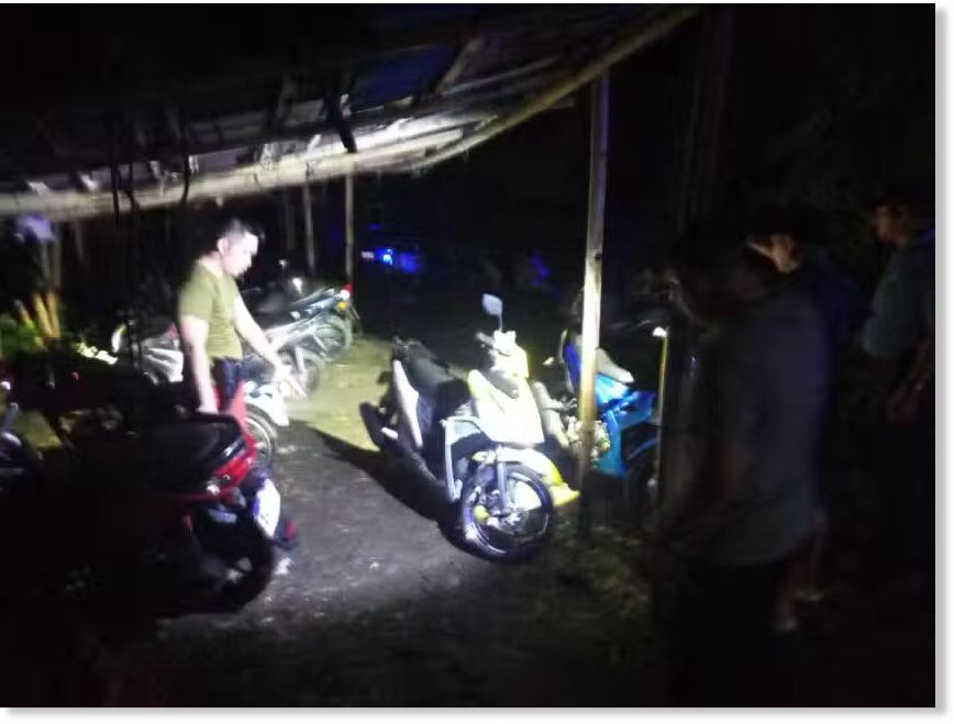 Police inspect the area where two officers were killed in a lightning strike after the cops parked their motorcycles at the Mimaropa Regional Mobile Force Battalion headquarters in Naujan, Oriental Mindoro, on Wednesday evening, May 14, 2025
