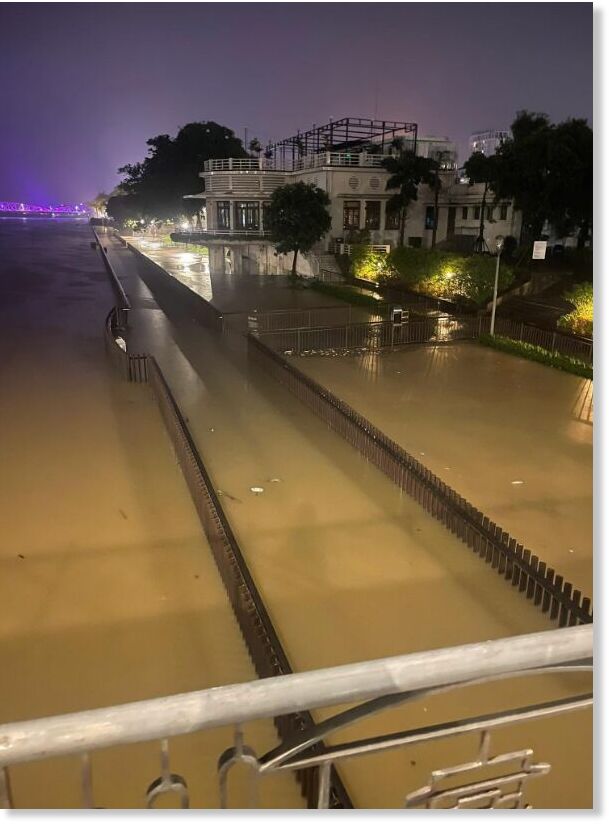 A pedestrian bridge along the Huong River is flooded.