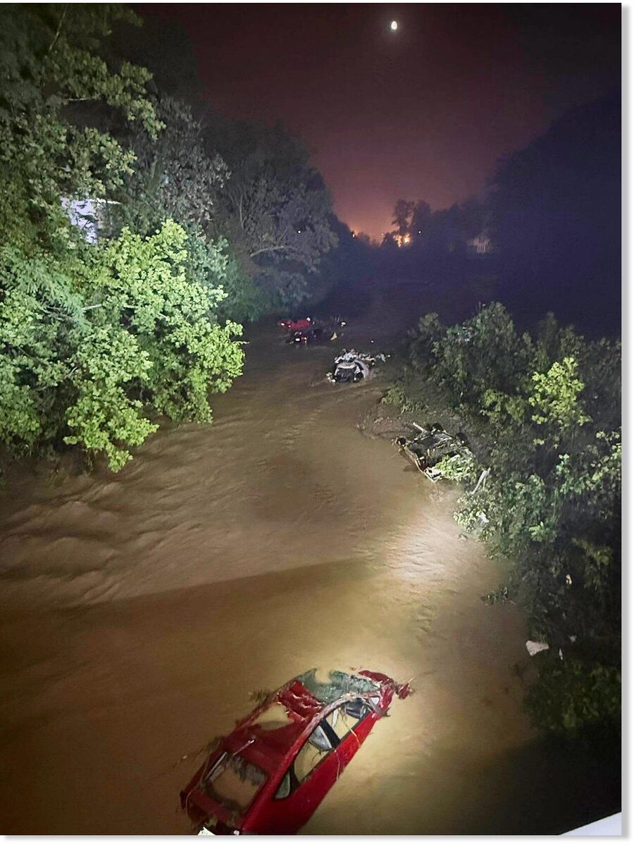 In this image provided by the Wheeling West Virginia Fire Department, cars sit submerged in floodwaters, Saturday, June 14, 2025, in Wheeling, West Virginia