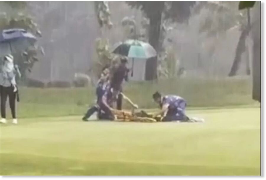 An image captured from a video shows rescuers assisting a caddie amid heavy rainfall after she was struck by lightning at a Bangkok golf club on Sept 18. She died in hospital on Tuesday, according to a relative.