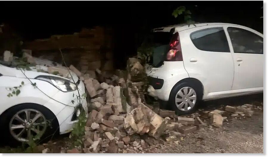 A wall collapsed due to the storm in Cordu, crushing parked cars beneath the debris.