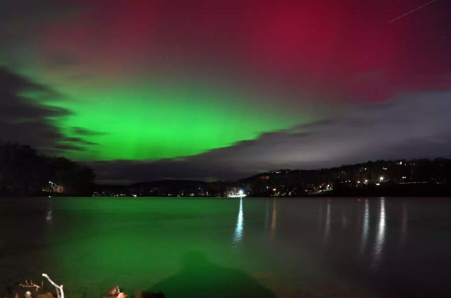 The aurora brightens the sky over Putnam Lake in Patterson, N.Y., on Tuesday.