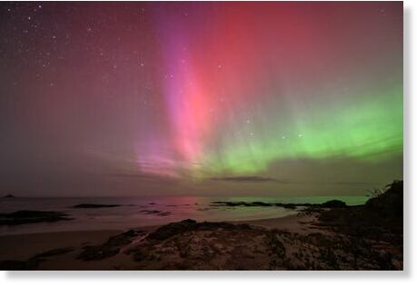 The southern lights glow over the waters of Brighton Beach in Dunedin.