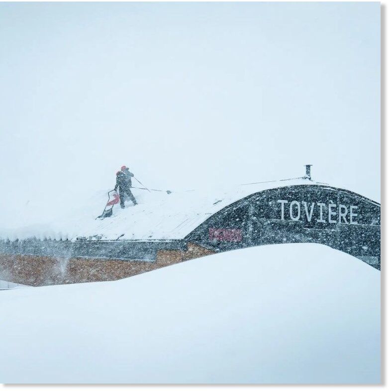 Staff clearing snow from a lift station.