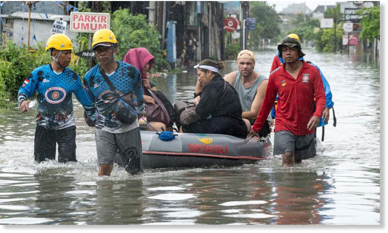 Tourists are evacuated among flooding in Badung regency, Bali, on Tuesday. Xinhua