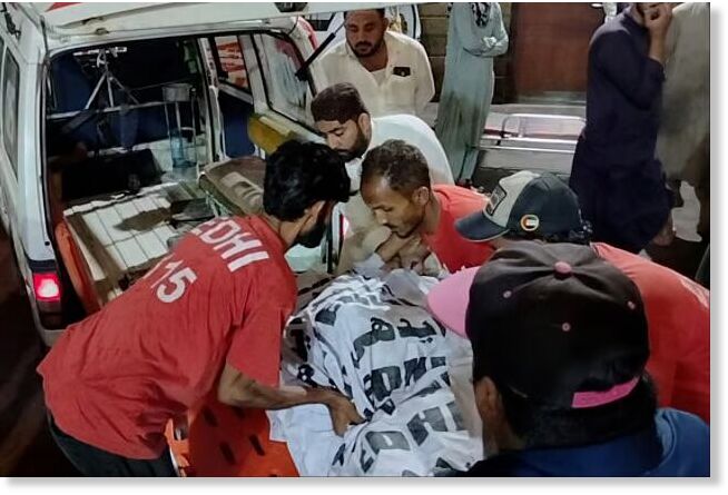 Rescue workers carry the body of a victim who died in an incident due to heavy rain strong winds, upon arrival at a hospital in Karachi, Pakistan, Thursday, March 19, 2026.