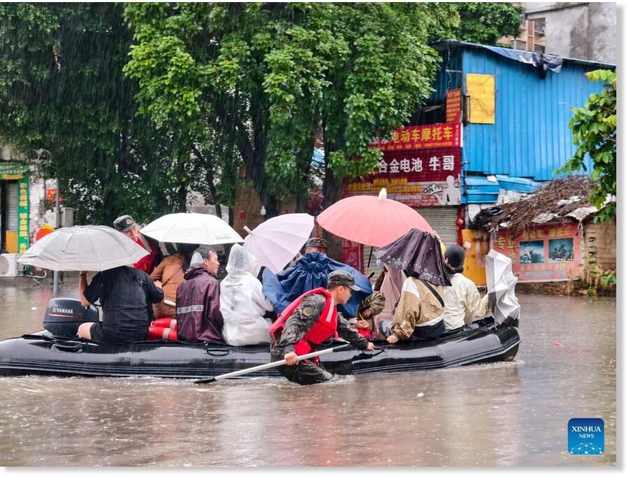 Stranded residents are transferred on a boat in Qinzhou, south China's Guangxi Zhuang Autonomous Region, April 27, 2026. Heavy rainfall hit Qinzhou on Monday.