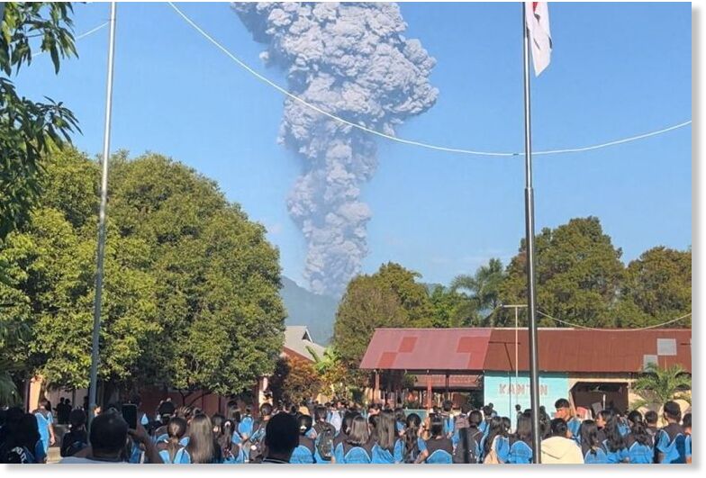 People watch as smoke rises after the eruption of Mount Dukono in North Halmahera Regency, North Maluku, Indonesia, on May 8, 2026 [